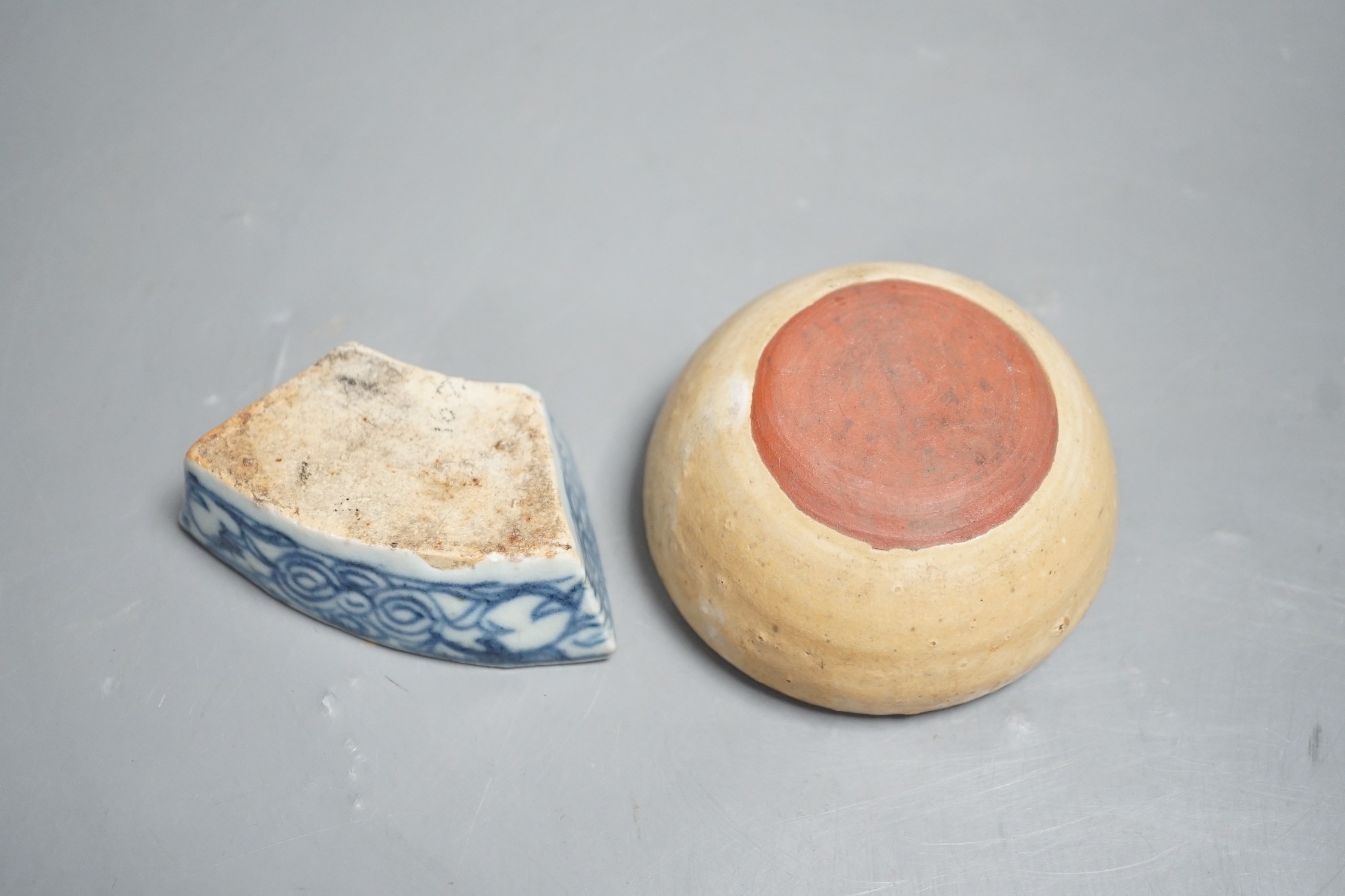 A Chinese late Qing blue and white penholder, 8cm and a South East Asian buff glazed cup